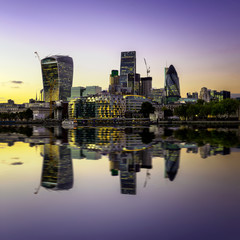 Fototapeta premium The bank district of central London with famous skyscrapers at sunset with amazing blue sky and reflection, London, United Kingdom