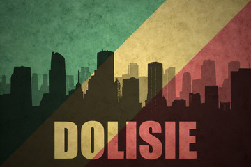 abstract silhouette of the city with text Dolisie at the vintage congolese flag