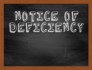 NOTICE OF DEFICIENCY handwritten text on black chalkboard