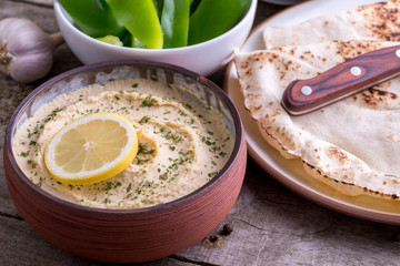 Humus in homemade bowl chapati and vegetable.