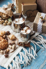 Metal mugs with cacao and marshmallows