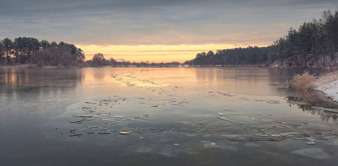 Autumn sunrise above frozen lake