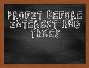 PROFIT BEFORE INTEREST AND TAXES handwritten text on black chalk