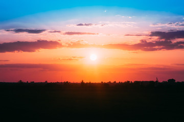 Scenic Red And Orange Sunset On Dramatic Cloudy Sky Over Dark Fi