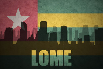 abstract silhouette of the city with text Lome at the vintage togo flag