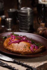 Meat pies, on top of a red onion and sauce