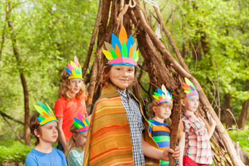 Cute boy wearing 's costume near his wigwam