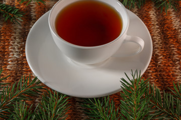 The Christmas tea. A Cup of tea. Christmas decor. In warm tones. Knitted background. Studio light