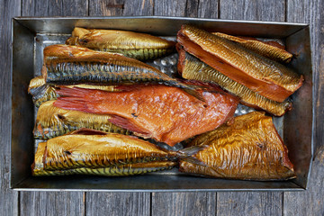 Set of smoked fish in a tin pan