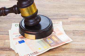 Wooden Law Gavel and Euro Money on wooden desktop