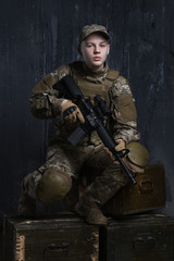 Portrait of a young soldier. The hands holding the rifle. Proud and confident quite complete.