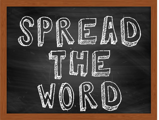 SPREAD THE WORD handwritten text on black chalkboard