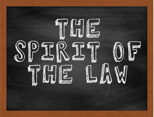 THE SPIRIT OF THE LAW handwritten text on black chalkboard