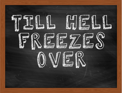 TILL HELL FREEZES OVER Handwritten Text On Black Chalkboard