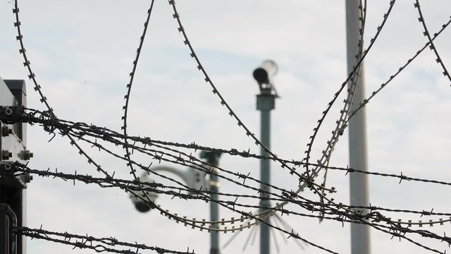 Barbed wire and security cameras