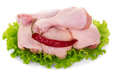 Raw chicken legs, salad leaves and red pepper isolated.