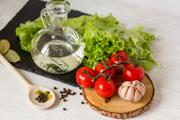 tomato with olive oil on wooden background close up
