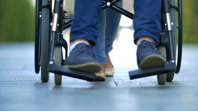 3 in 1 video! The woman walk with a disabled on a wheelchair. Slow motion