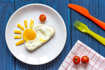 sunshine fried eggs breakfast for kid on blue background