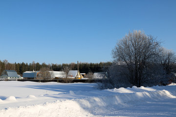 Fototapeta na wymiar Village in a winter day and snow