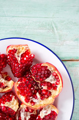 pomegranate seeds on wooden surface