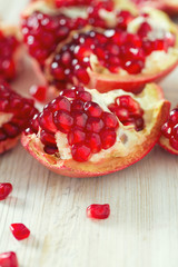 pomegranate seeds on wooden surface
