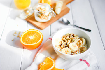 healthy breakfast bowl of yogurt with granola and banana