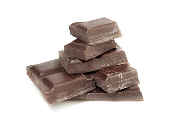 Pieces of dark chocolate isolated on white background
