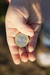 coin in the hands of a child