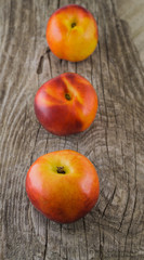 Mellow nectarines on rough rustic wooden background close up sel