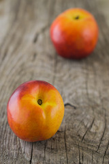 Nectarine on rough rustic wooden background close up selective f