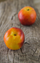 Nectarines on rough rustic wooden background close up selective