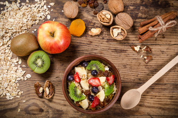 Food background with oatmeal and fruits on wooden table