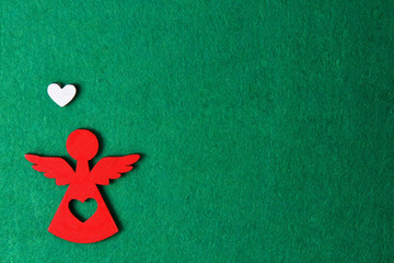 Christmas angel on a green background, wooden eco decoration, toy