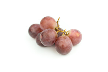 Ripe red grape with leaves isolated on white