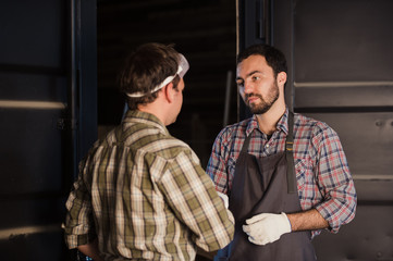 Male architects shaking hands at construction site