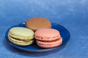 Macarons or macaroons on blue background