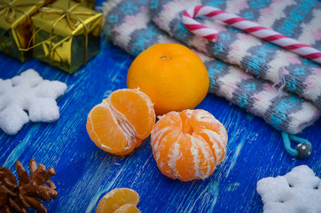 Christmas Card.Christmas composition with tangerines on a blue wooden board. New Year holiday decoration.