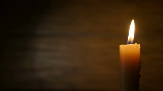 Burning Candle on a Dark Background