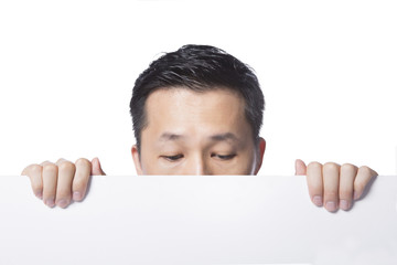 Man hiding behind the white paper