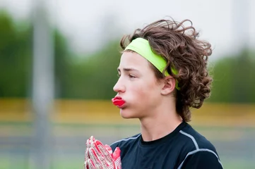 Foto op Plexiglas Youth football boy with long hair © tammykayphoto