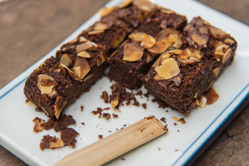 Delicious cake chocolate walnut brownies on wooden desk