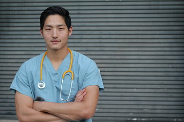 Male health care worker crossing his arms with copy space