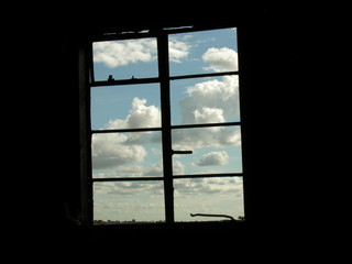 Cloudy sky through a barn window