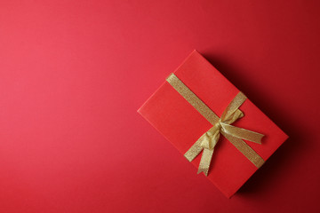 Single present on plain red background