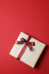Single present on plain red background