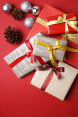 Presents with christmas decoration on red background