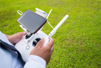 Hand holding on remote for Control drone with smart phone or teb