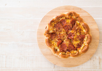 Homemade Pepperoni Pizza on wood plate