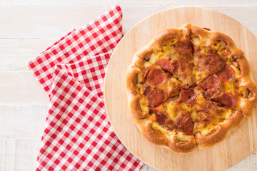 Homemade Pepperoni Pizza on wood plate